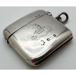 An antique curve backed silver vesta case with Family crest to front with inscription "Exaltabit