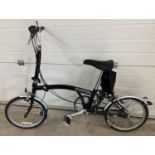 A Brompton L3 folding bike in black, with original purchasers receipt. Complete with instruction