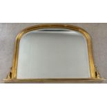 A large gilt frame wall hanging over mantle mirror with scroll detail to sides. Approx. 78 x 124cm.