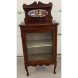 An Edwardian mahogany mirror backed display cabinet with upper shelf, front cabriole legs and