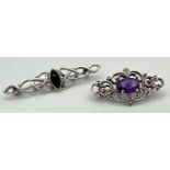 2 decorative silver stone set brooches. A celtic design bar brooch set with marquise cut black onyx,