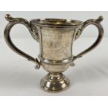 A vintage silver trophy cup with large decorative handles. Hallmarked London 1923. Approx. 9cm