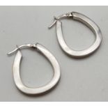 A pair of 9ct white gold hoop style earrings. Posts marked 375. Total weight approx. 3.4g. Total