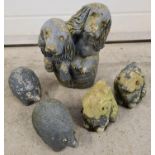 5 vintage concrete garden ornaments of animals. 2 rabbits, 2 hedgehogs and a figure of 2 dogs in a