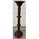 A modern mahogany coloured torchere with twist stem design. Approx. 98cm tall, diameter of