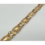 A vintage 9ct gold bracelet with 8 decorative pierced work panels and spring clasp. Total length