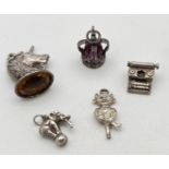 5 assorted vintage white metal charms, all unmarked. To include a stone set coronation crown, an