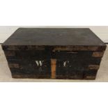 A vintage pine box, painted black with metal banded corners and lid edging. Painted 'W.C' monogram