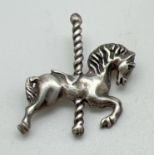 A 925 silver pin back brooch in the form of a merry-go-round horse. Approx. 3.5cm tall, stamped