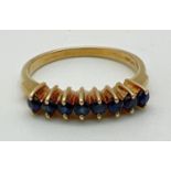 A 14ct gold half eternity style ring set with 8 small round cut sapphires. Hallmarked to inside of