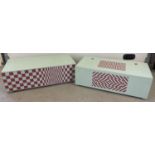 2 large painted wooden storage/toy chests decorated with optical illusion patterns. Both with lift