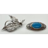 2 decorative silver brooches. A vintage leaf design brooch together with an oval shaped brooch set