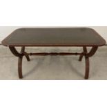 A vintage Bevan Furniture 'Reprodux' x frame coffee table with green leather insert to top.