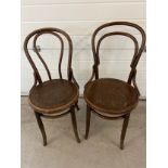 A pair of vintage European dark wood bentwood bistro chairs by Mundus and J&J Kohn. With embossed