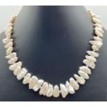 A 16" Heishi freshwater pearl necklace with crystal beaded ends and silver tone T bar clasp. Retired