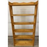A modern pine open backed 6 shelf bookcase with shaped top. Approx. 124cm tall x 61cm wide.