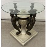 A modern circular glass topped coffee table of classical design. Heavy resign base with central