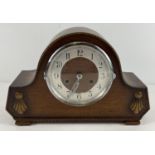 A vintage dark oak cased striking mantel clock with embossed beading and detail to front. Complete