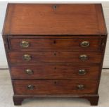 A Georgian mahogany 4 drawer bureau with drop down handles, brass lock and interior stationery