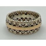 A vintage duo coloured 9ct gold full eternity ring with heart decoration, set with multiple clear