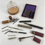 A collection of vintage watch makers tools. To include a glass domed topped parts container, blades,