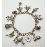A vintage silver charm bracelet with padlock clasp and 12 charms. Charms include: a castle, bumble