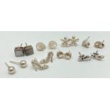 8 pairs of silver and white metal stud style earrings. To include: cats, crystal set shoes, stars,