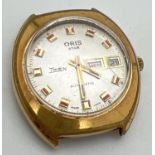 A vintage Oris Star Twen automatic watch with date and day function. Gold plated case with red and