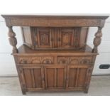 A vintage medium oak Old Charm court cupboard with Gothic style metal drop down handles & hinges.