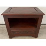 A vintage Chinese style unit with painted red mahogany effect and carved detail. Open shelf to front