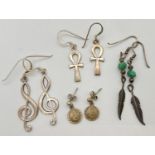 4 pairs of silver and white metal drop earrings. To include 3.5cm drop treble clef earrings and 2.