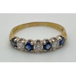 An 18ct gold sapphire and diamond half eternity style dress ring. Alternating blue sapphires and