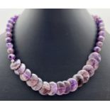 A 15" necklace made from spherical and flat round amethyst beads. With silver tone S shaped hook