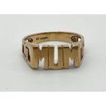 A 9ct gold "MUM" dress ring with Greek key design to shoulders. Full hallmarks to inside of band.