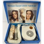 A boxed vintage Ronson Escort 2000 hairdryer. Complete with hot air comb & brush, cap and shoulder