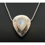 A modern design silver teardrop shaped pendant set with a moonstone cabochon. On a 22 inch snake