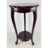 A modern mahogany coloured circular jardiniere/lamp stand with shaped legs and carved edging.