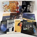 12 assorted 1980's vinyl LP's to include gate sleeve examples. Artists include: Dire Straits, Paul