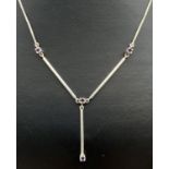 A silver modern design drop style fixed pendant necklace, set with 4 small round cut amethysts.
