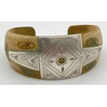 An ethnic style horn cuff bangle with white metal engraved panels and inlay.