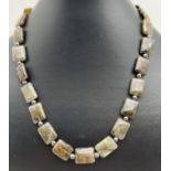 An 18" necklace of alternating square shaped labradorite and hematite beads. With silver tone S hook