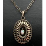 A vintage gold plated pendant set with central oval shaped opal. On a 21" yellow metal belcher style