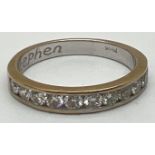 An 18ct gold modern design channel set diamond half eternity ring. 12 round cut diamonds, each