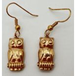 A pair of yellow gold drop style earrings in the shape of owls. Total drop including hooks approx.