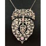 An antique ornate silver drop style pendant necklace which converts to a dress clip. Pierced work