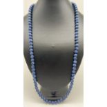 A 29" blue jasper beaded necklace with silver tone magnetic barrel clasp. Spherical polished blue