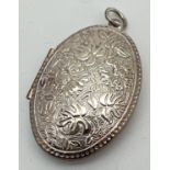 A large silver oval shaped locket with floral embossed decoration to front and back. Marked 925 to