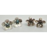 2 large pairs of flower design stud style earrings. One pair set with central freshwater peacock