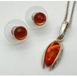 A modern design silver & amber pendant together with a small pair of amber set round stud