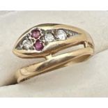 A vintage 9ct gold serpent design ring set with diamonds and with ruby eyes. Total diamonds